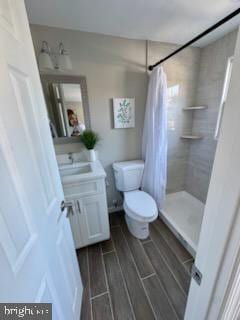 bathroom with vanity, a shower with curtain, and toilet