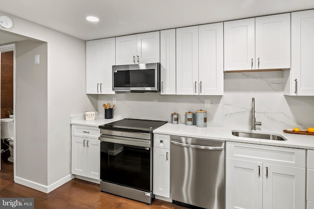 kitchen featuring stainless steel appliances, sink, and white cabinets