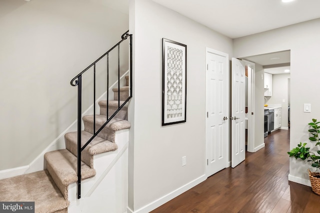 staircase featuring wood-type flooring