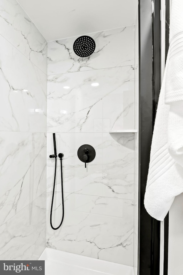 bathroom with tiled shower