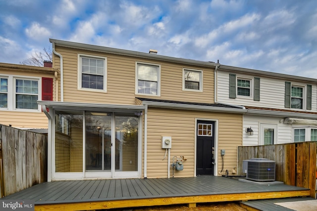 rear view of property with a wooden deck and central air condition unit