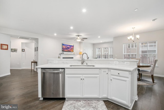 kitchen featuring white cabinetry, a kitchen island with sink, hanging light fixtures, stainless steel dishwasher, and sink