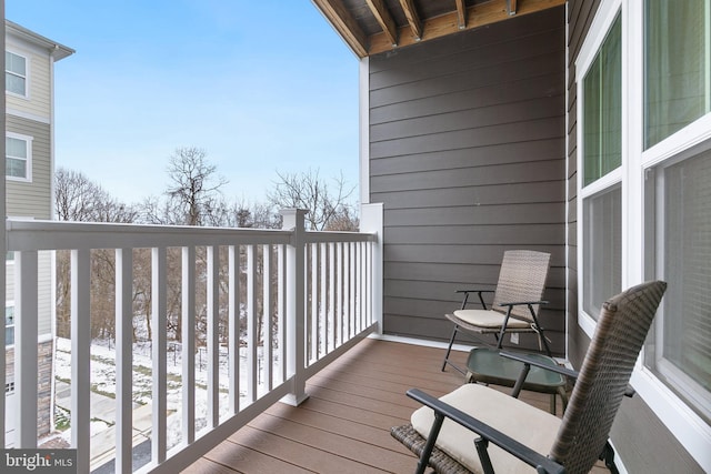 view of snow covered back of property