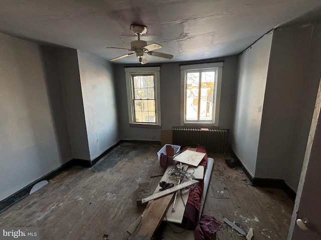 misc room featuring dark wood-type flooring and ceiling fan