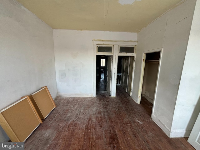 spare room with dark wood-type flooring