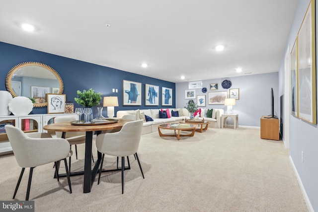 dining space featuring light colored carpet