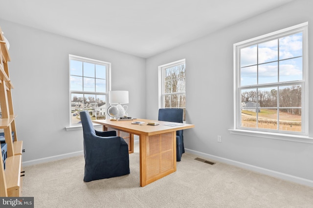 office with a wealth of natural light and light carpet