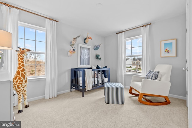 bedroom featuring a crib and light colored carpet