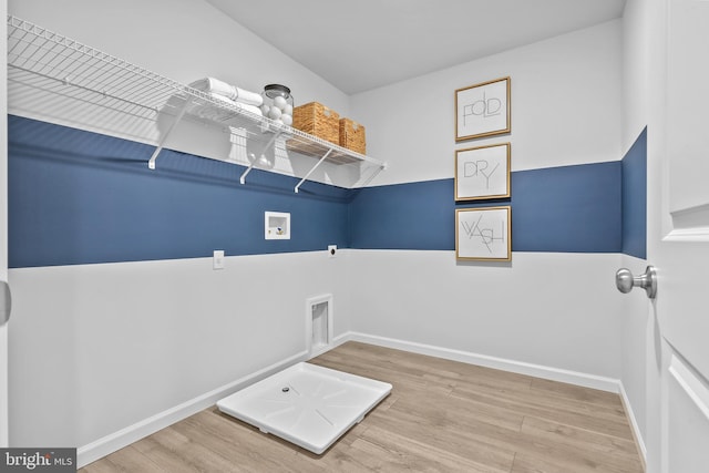 clothes washing area with hardwood / wood-style floors, hookup for a washing machine, and hookup for an electric dryer