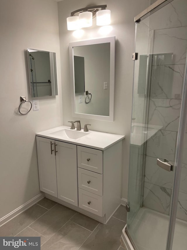 bathroom featuring an enclosed shower, vanity, and tile patterned floors