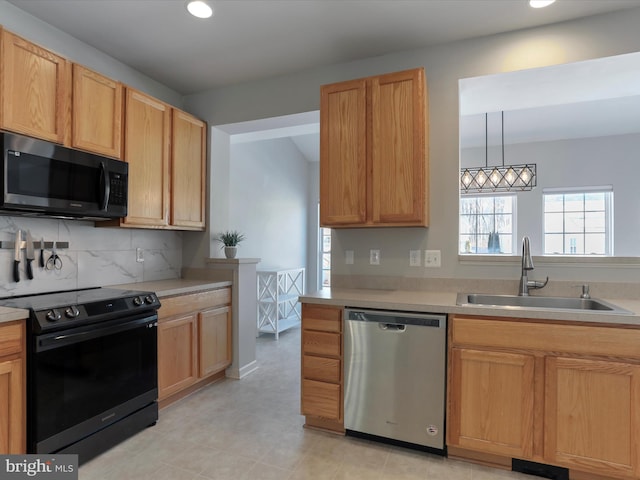 kitchen featuring sink, backsplash, hanging light fixtures, stainless steel dishwasher, and black electric range