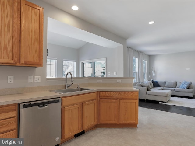 kitchen with dishwasher, sink, a healthy amount of sunlight, and kitchen peninsula