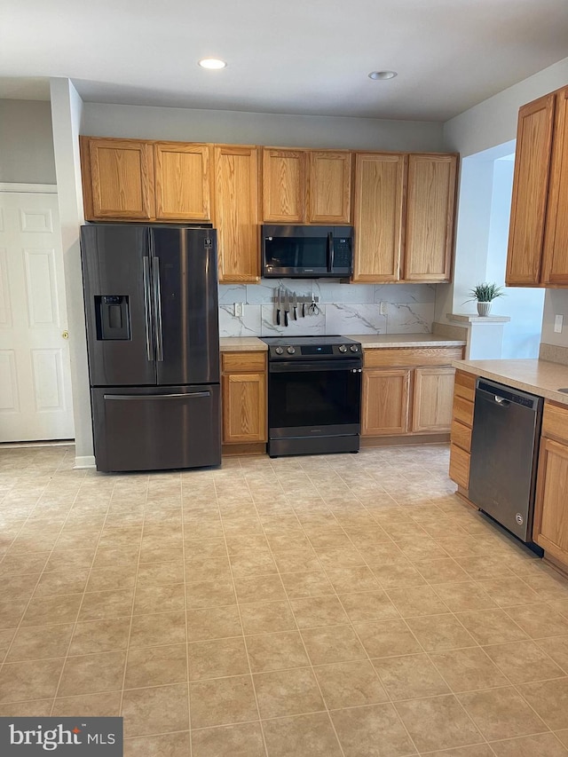 kitchen with tasteful backsplash, light tile patterned floors, electric range, dishwasher, and refrigerator with ice dispenser