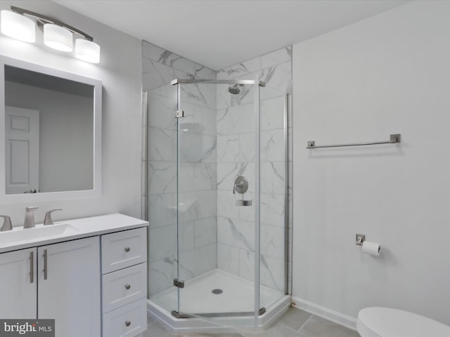 bathroom with tile patterned flooring, vanity, toilet, and walk in shower