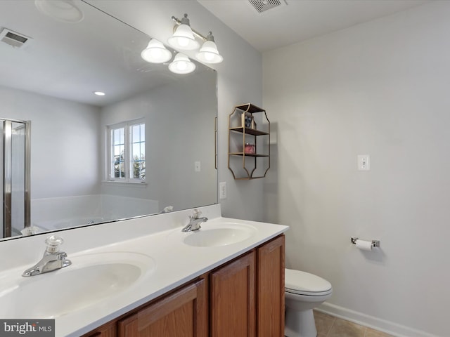 bathroom featuring vanity, toilet, tile patterned flooring, and a bathtub