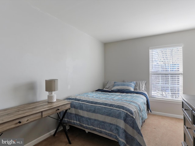 carpeted bedroom featuring multiple windows