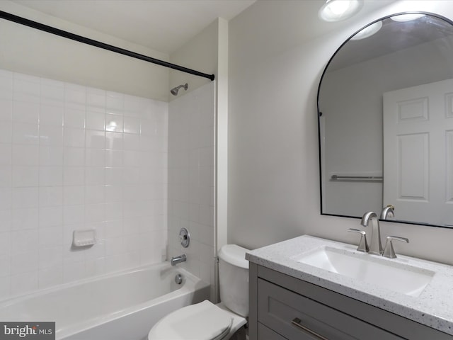 full bathroom featuring vanity, tiled shower / bath combo, and toilet