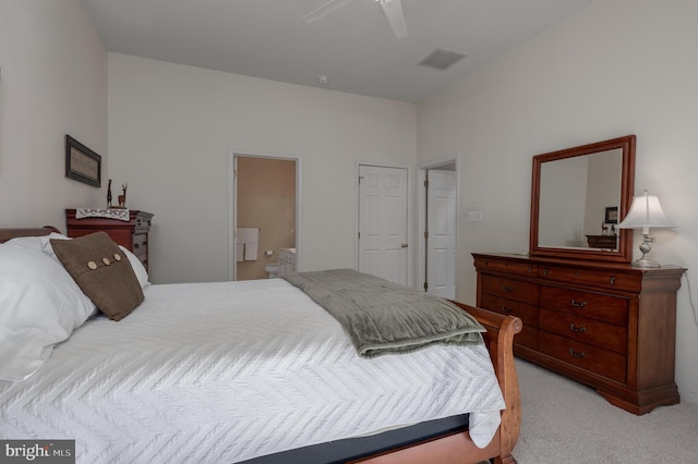 carpeted bedroom with connected bathroom and ceiling fan