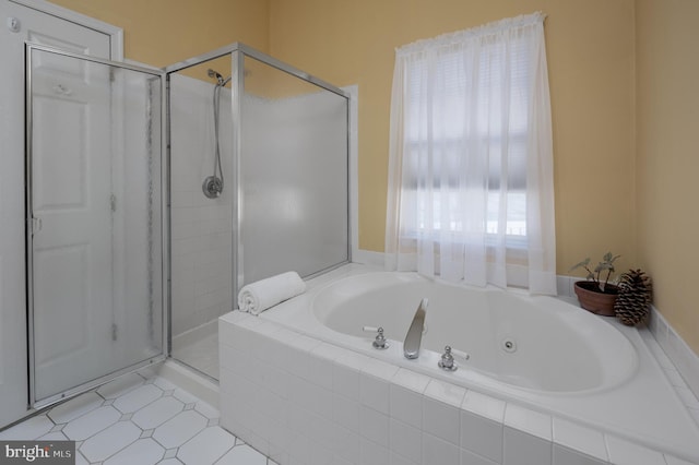 bathroom featuring separate shower and tub