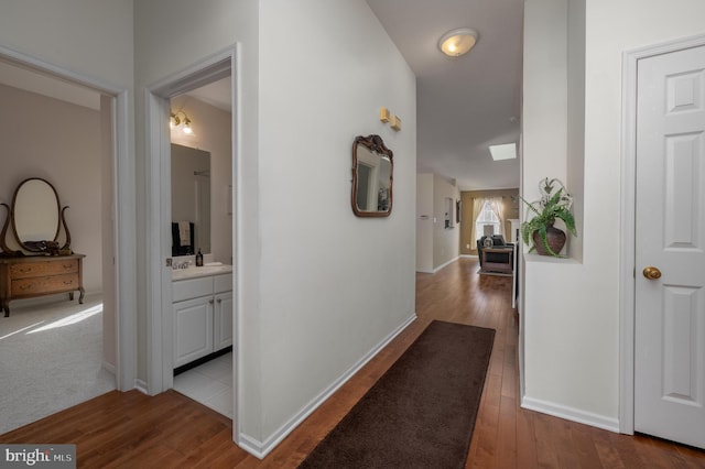 hallway with light hardwood / wood-style flooring