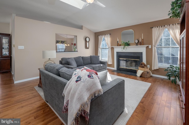 living room with ceiling fan, hardwood / wood-style floors, and plenty of natural light