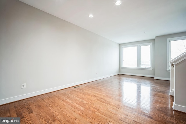 spare room with hardwood / wood-style flooring