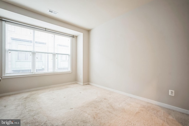 spare room with light carpet