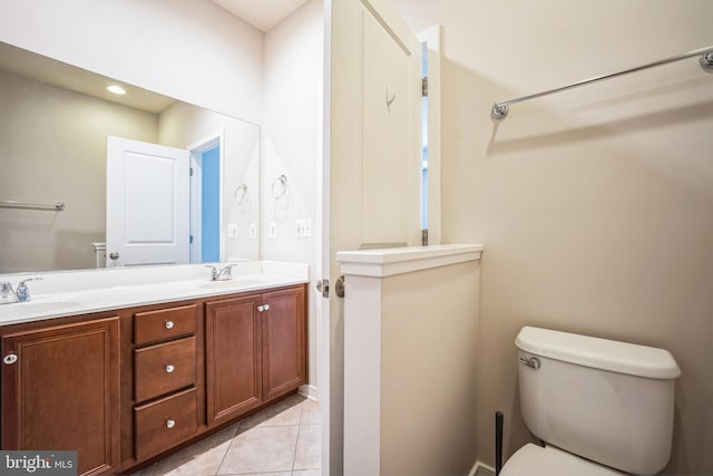 bathroom featuring toilet, tile patterned floors, and vanity