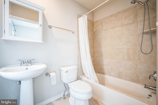 full bathroom featuring sink, toilet, tile patterned floors, and shower / tub combo with curtain