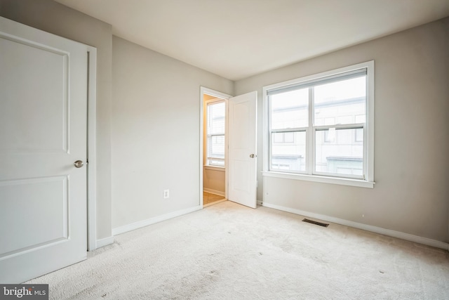 unfurnished bedroom with light colored carpet