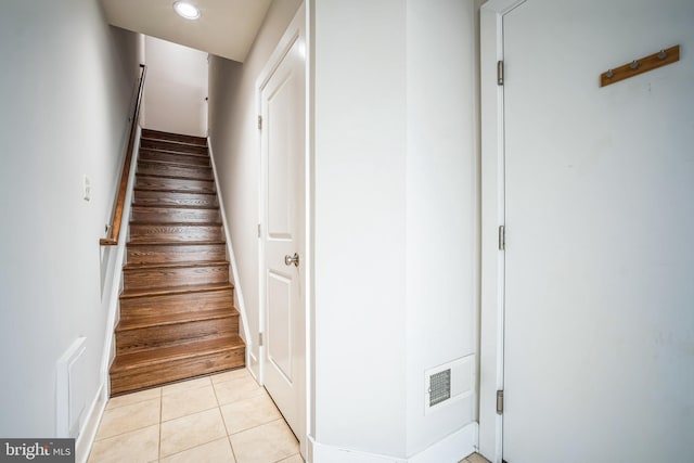 stairway featuring tile patterned flooring