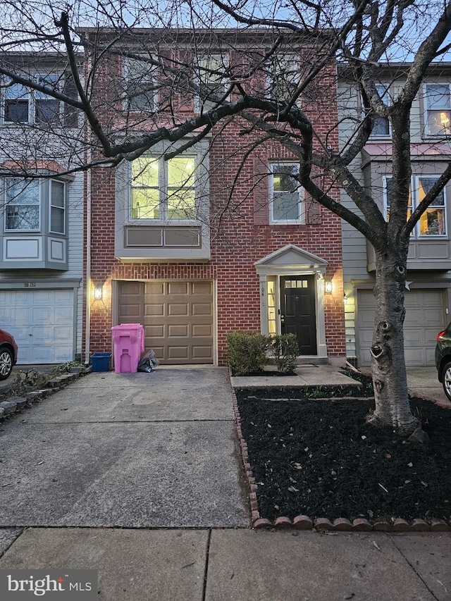 view of front of home with brick siding, concrete driveway, and a garage