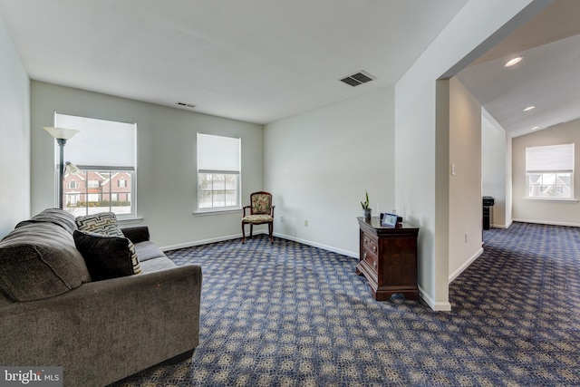 carpeted living room featuring vaulted ceiling