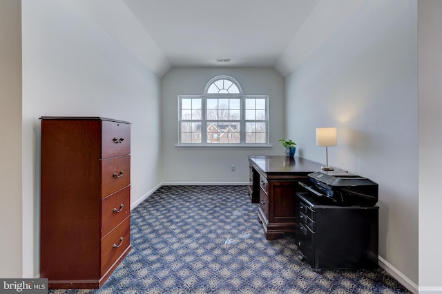 home office featuring vaulted ceiling and dark colored carpet