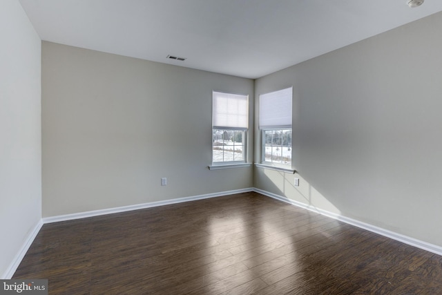 unfurnished room featuring dark hardwood / wood-style flooring