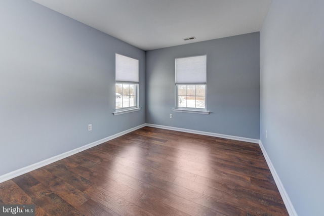 empty room featuring dark hardwood / wood-style flooring