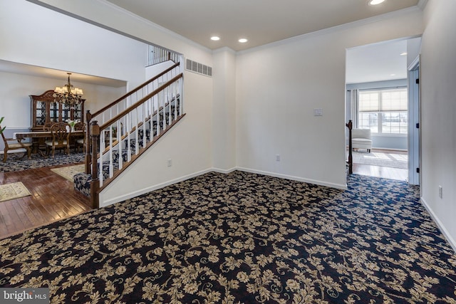 interior space featuring ornamental molding, carpet flooring, and a chandelier