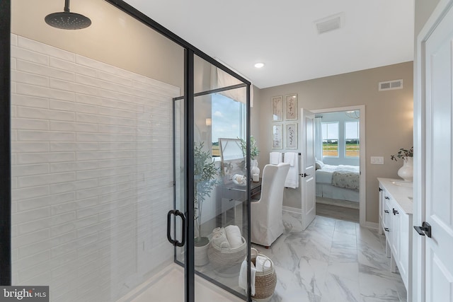 bathroom with vanity and a shower with shower door