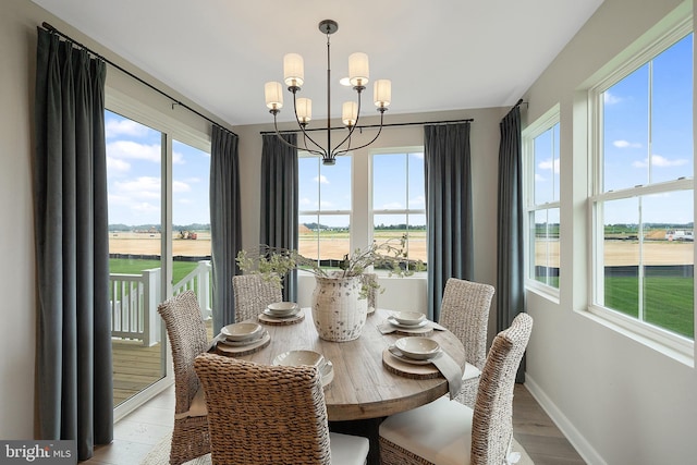 dining space featuring an inviting chandelier and light hardwood / wood-style flooring