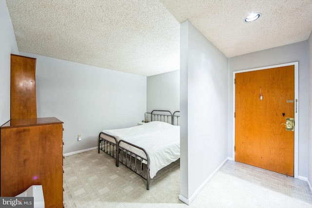 carpeted bedroom with a textured ceiling