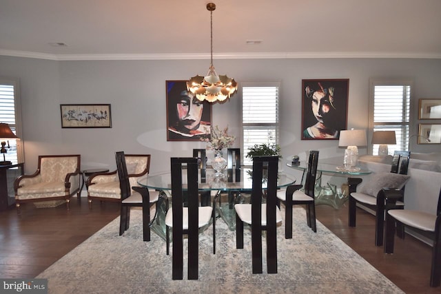 dining area featuring an inviting chandelier, ornamental molding, and dark hardwood / wood-style flooring