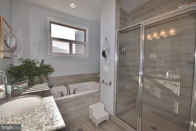 bathroom with separate shower and tub, wood-type flooring, and vanity