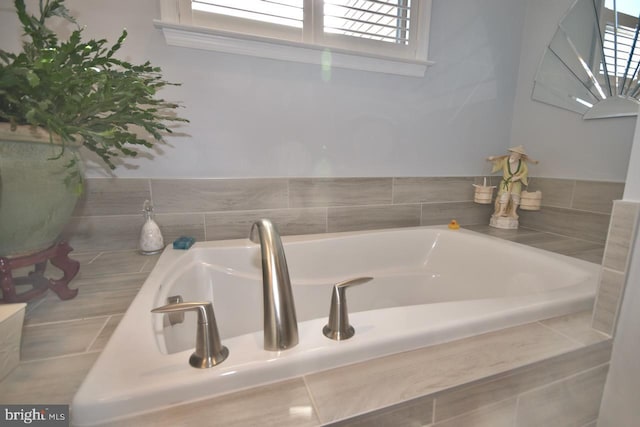 bathroom featuring tiled bath