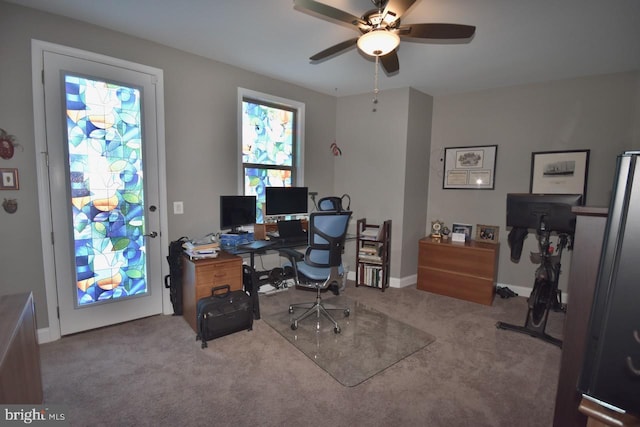 office space with light carpet and ceiling fan