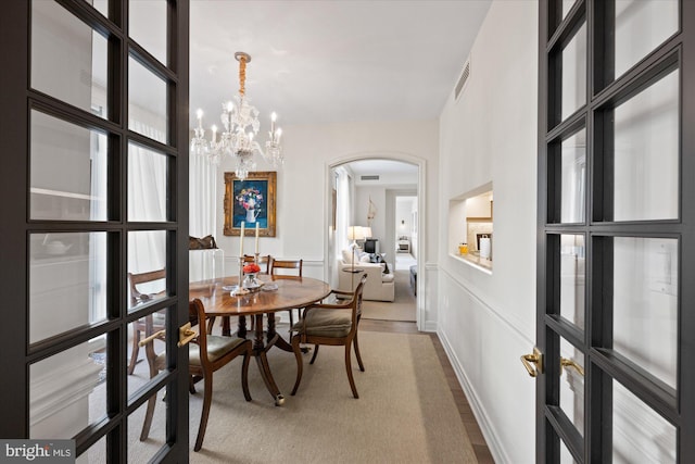 dining area with a healthy amount of sunlight and a chandelier