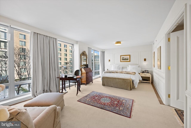 carpeted bedroom featuring multiple windows