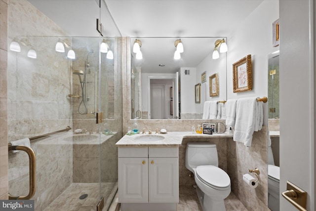 bathroom featuring toilet, tasteful backsplash, tile walls, vanity, and a shower with door