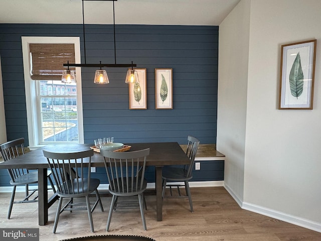 dining space with wood-type flooring