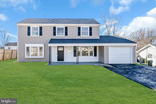 view of front property featuring cooling unit, a garage, and a front yard