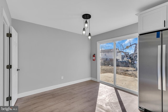 unfurnished dining area with light hardwood / wood-style floors